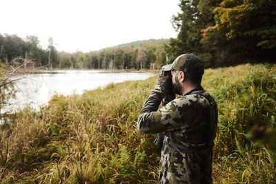 Full length of man standing by lake