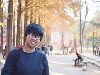 Portrait of smiling man wearing eyeglasses in park