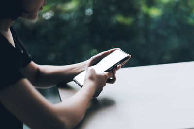 Midsection of woman using mobile phone