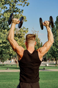 Rear view of man exercising at park