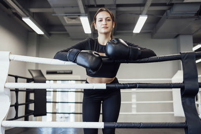 Portrait of young woman exercising in gym