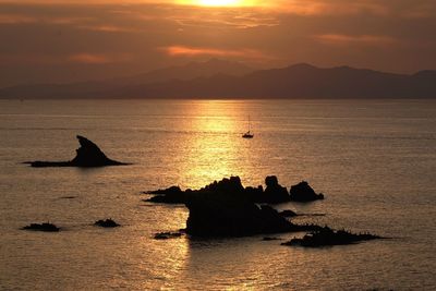 Silhouette of rock formations in the sea