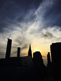 Low angle view of buildings against cloudy sky