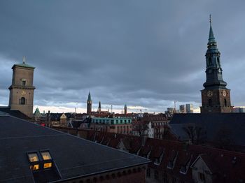 Houses against cloudy sky