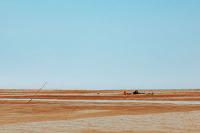 View of sandy beach against clear sky