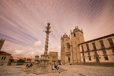 Monument by porto cathedral against sky during sunset