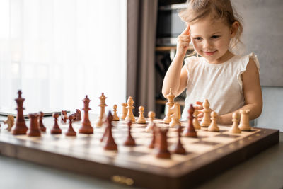Boy playing chess at home