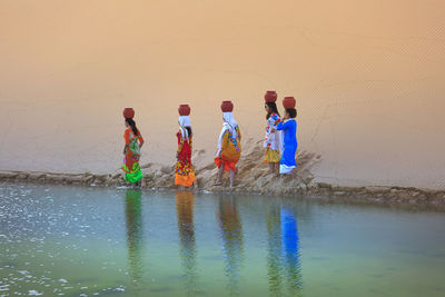 Children playing on shore at beach