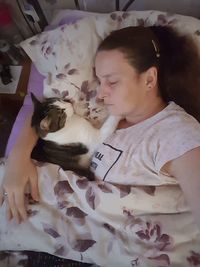 Close-up of cute girl with dog on bed