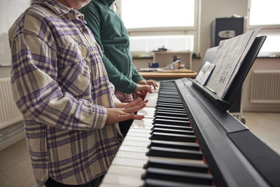 Children playing keyboard instrument