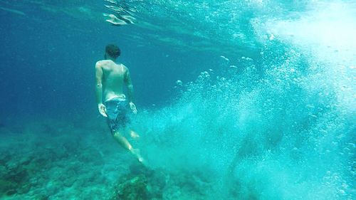 High angle view of man swimming in sea