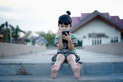 Full length of a boy holding camera