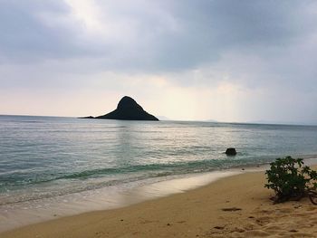 Scenic view of sea against cloudy sky