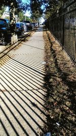 Shadow of railing on walkway