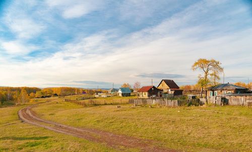 Houses on field against sky