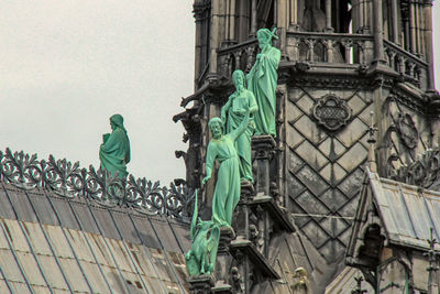 Statue against historic building