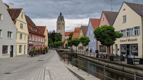 Street amidst buildings in city against sky