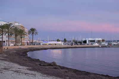 View of harbor at beach against sky