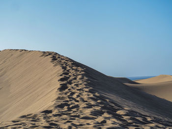 Scenic view of desert against clear sky