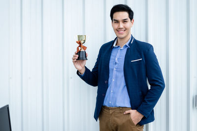 Smiling young man standing in a room
