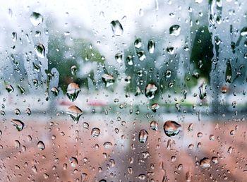 Full frame shot of wet glass window in rainy season