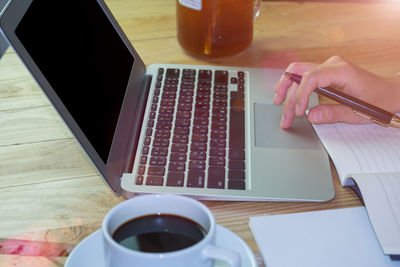 Midsection of coffee cup on table