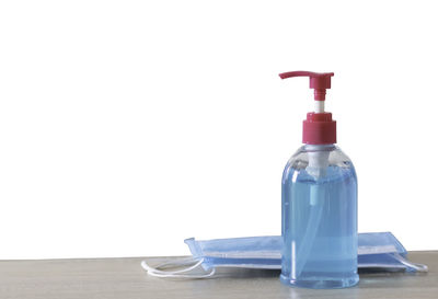 Close-up of bottle on table against white background