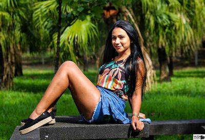 Beautiful young woman sitting outdoors