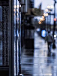 Close-up of wet glass door in city