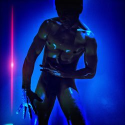 Full length of shirtless man against blue background