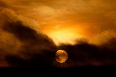 Low angle view of moon against sky at sunset