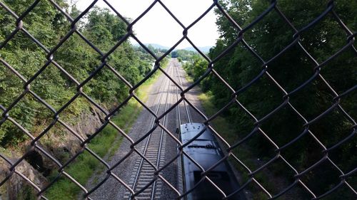 Close-up of chainlink fence against sky