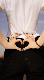 Midsection of woman holding umbrella standing