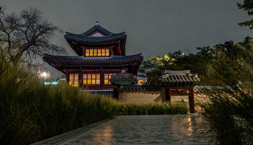 Temple by building against sky