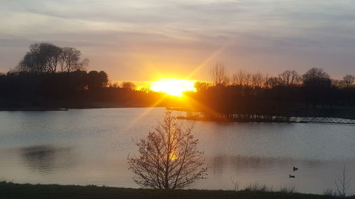 Scenic view of lake against sky during sunset