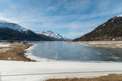 Switzerland, february 21, 2023 view over the lake of silvaplana and the mount corvatsch