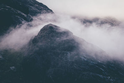 Scenic view of mountains amidst fog