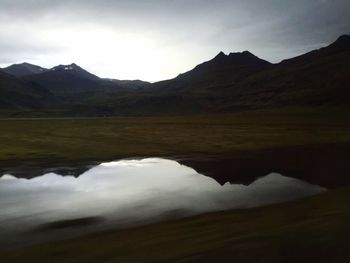 Scenic view of lake and mountains against sky