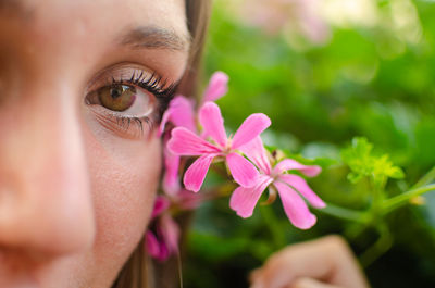 Close-up of young woman by plant