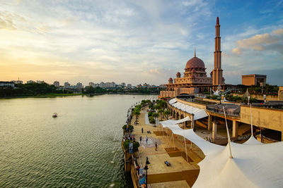 Putra mosque by lake against sky