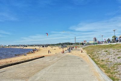 People on beach against sky