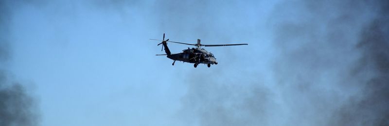 Low angle view of helicopter against sky