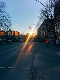 View of city street at sunset