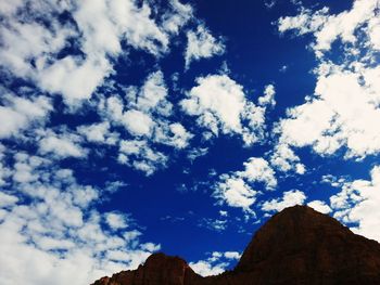 Low angle view of mountain against cloudy sky