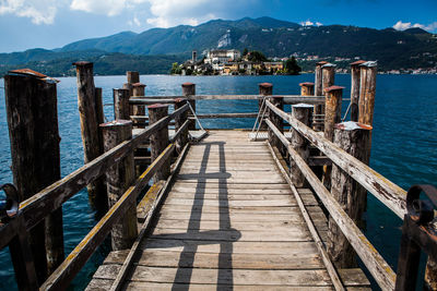 Pier by sea against sky in city