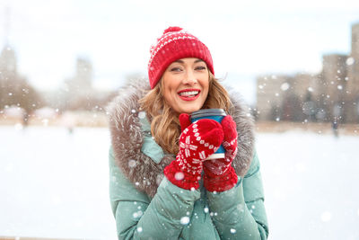 Portrait of a smiling young woman in snow