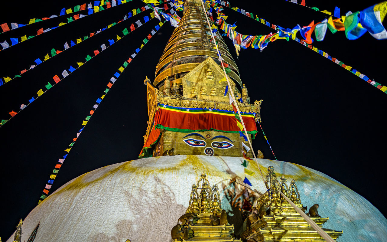 religion, belief, spirituality, temple - building, architecture, travel destinations, place of worship, built structure, decoration, no people, building, travel, gold, tradition, night, history, pagoda, flag, nature, multi colored, the past, sculpture, building exterior, outdoors, tourism, city, sky, ancient, statue, event