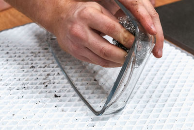 Cropped image of man cleaning bowl