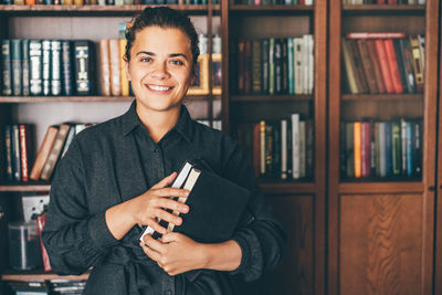 Portrait of young woman reading book