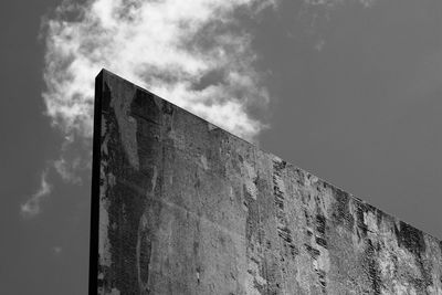 Low angle view of building against cloudy sky